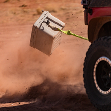 Load image into Gallery viewer, Expedition Cooler Truck Gear by LINE-X being dragged by a jeep demonstrating durability