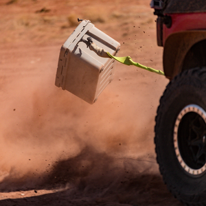 Expedition Cooler Truck Gear by LINE-X being dragged by a jeep demonstrating durability